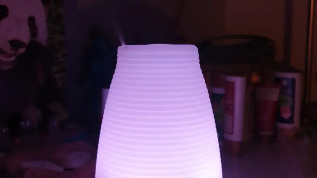 A modern aroma diffuser releasing a fine mist