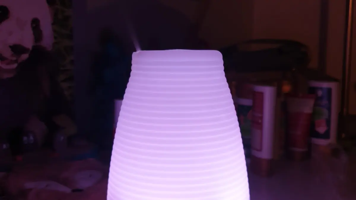 A modern aroma diffuser releasing a fine mist