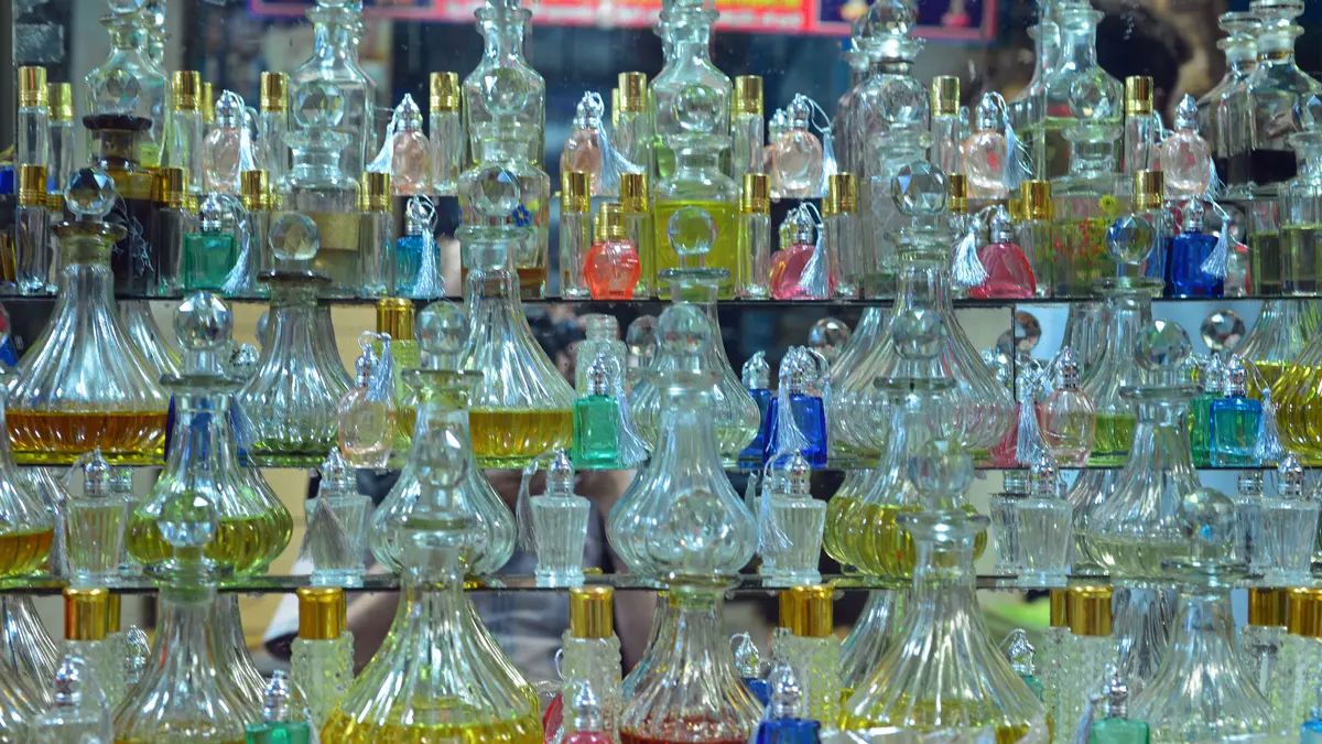 A market display of many small glass perfume and essential-oil bottles