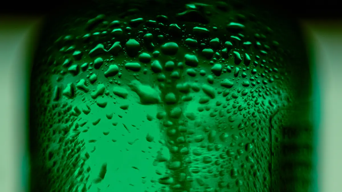 Close view of water droplets on a green spray bottle