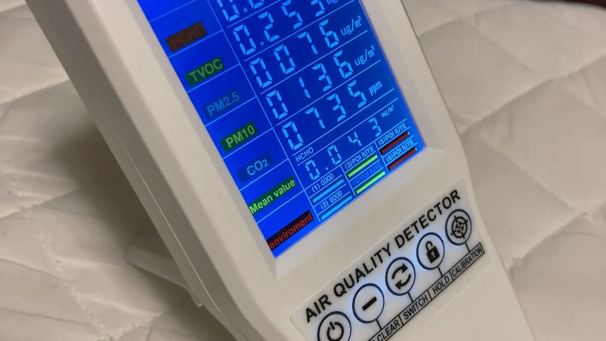 A portable electronic monitor measuring indoor air quality