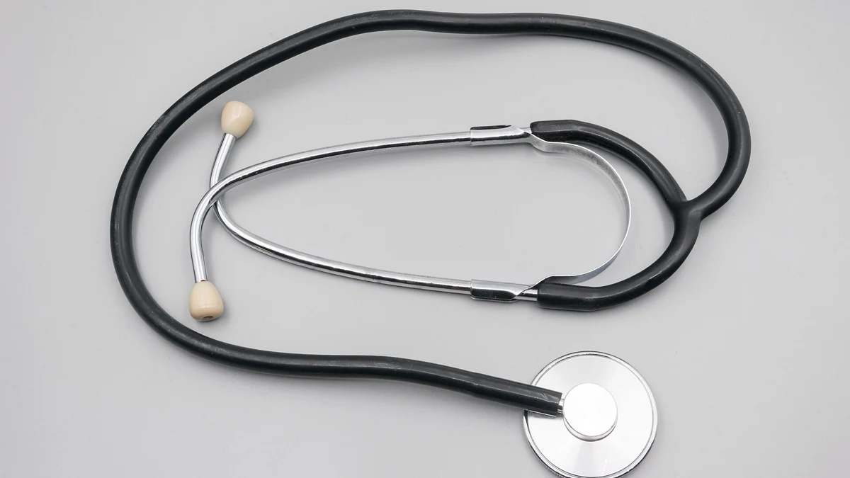 A stethoscope on a plain grey surface