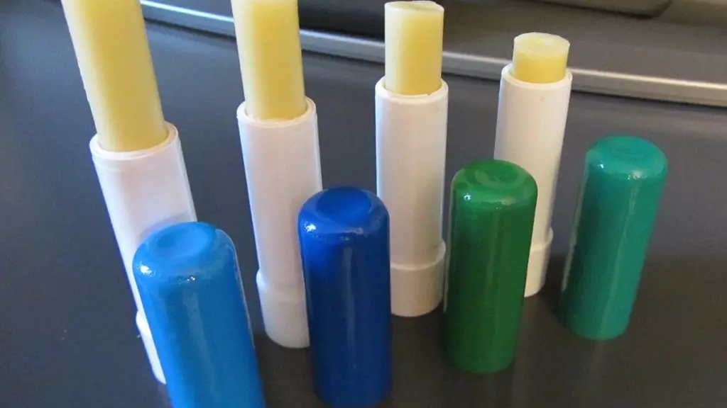 Several open lip balm sticks with coloured caps