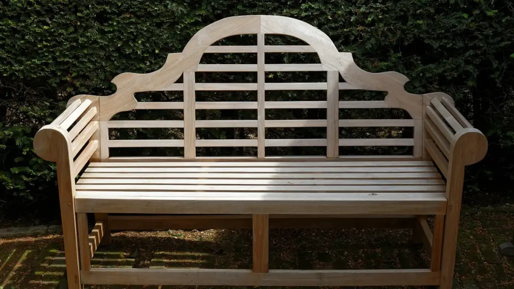 An empty wooden bench in a garden