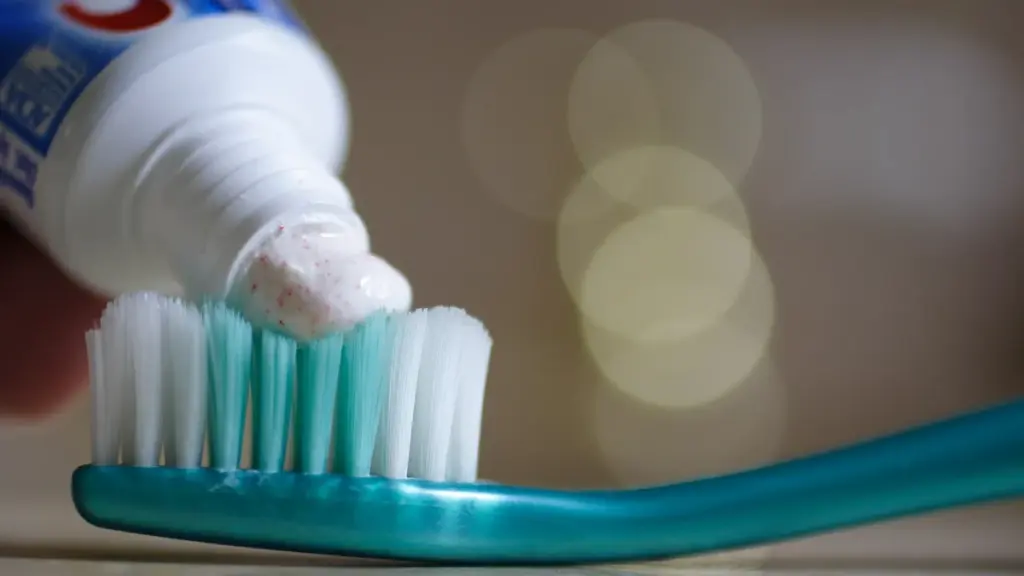 Toothpaste being applied to a toothbrush