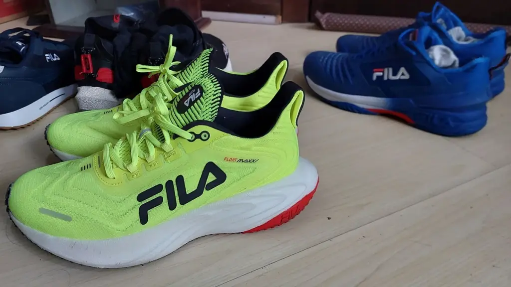 Several pairs of running shoes on a floor